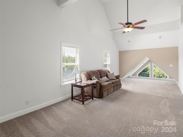 sitting room with carpet floors, ceiling fan, and high vaulted ceiling