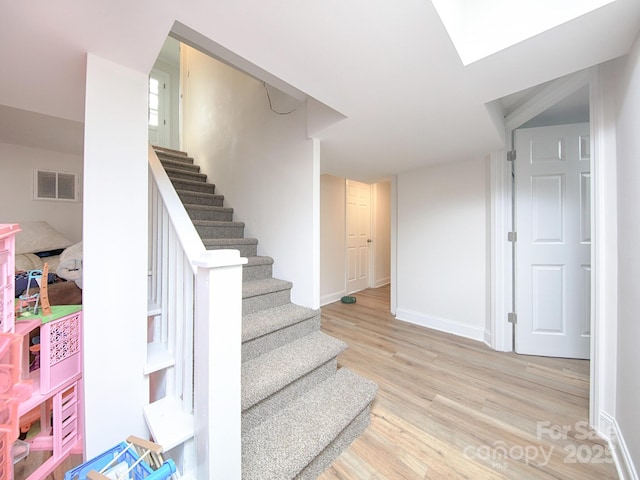 stairs featuring wood-type flooring