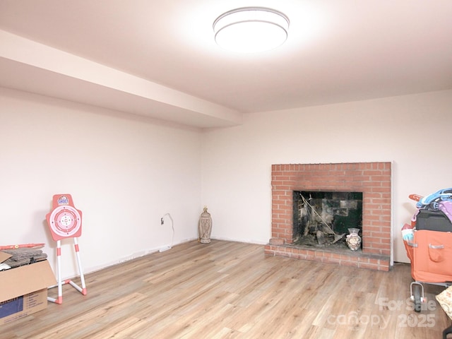 interior space with a fireplace and light hardwood / wood-style flooring