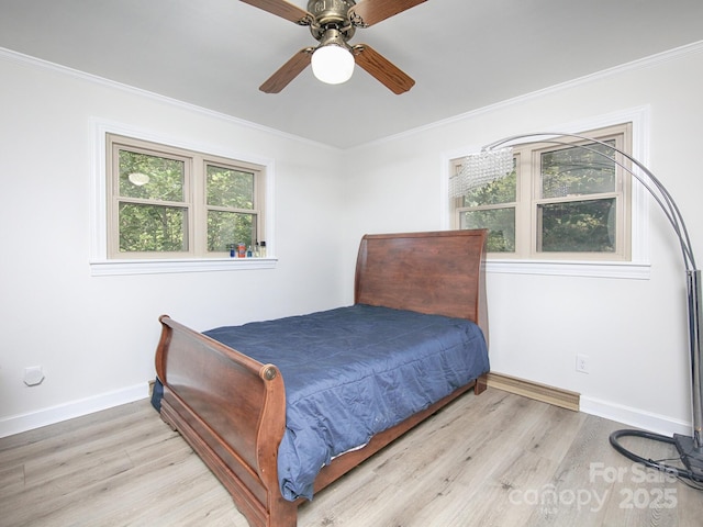 bedroom with crown molding, ceiling fan, and light wood-type flooring