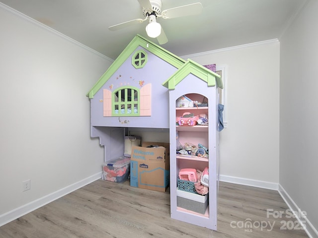 bedroom featuring hardwood / wood-style flooring, ceiling fan, and ornamental molding