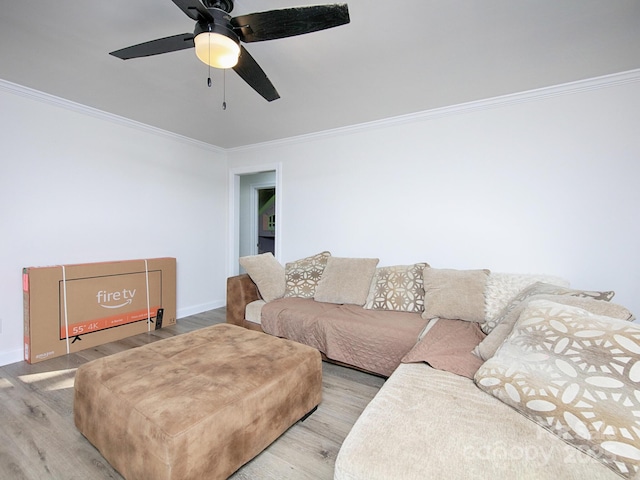 living room featuring crown molding, ceiling fan, and light hardwood / wood-style floors