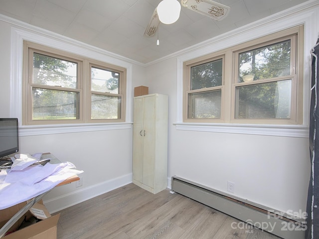 office space with a baseboard heating unit, crown molding, light hardwood / wood-style floors, and ceiling fan