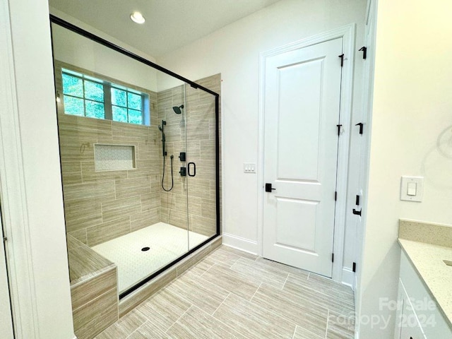 bathroom with vanity and an enclosed shower