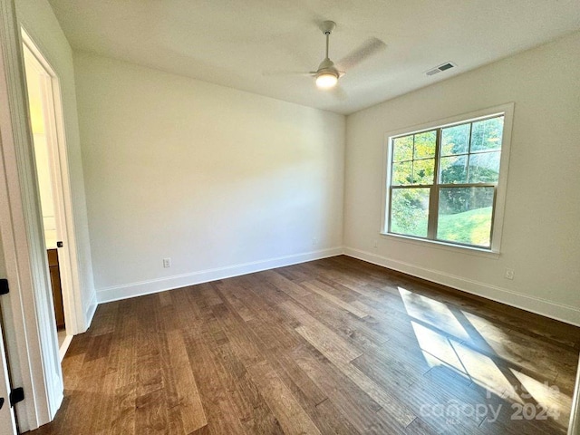 spare room featuring wood-type flooring and ceiling fan