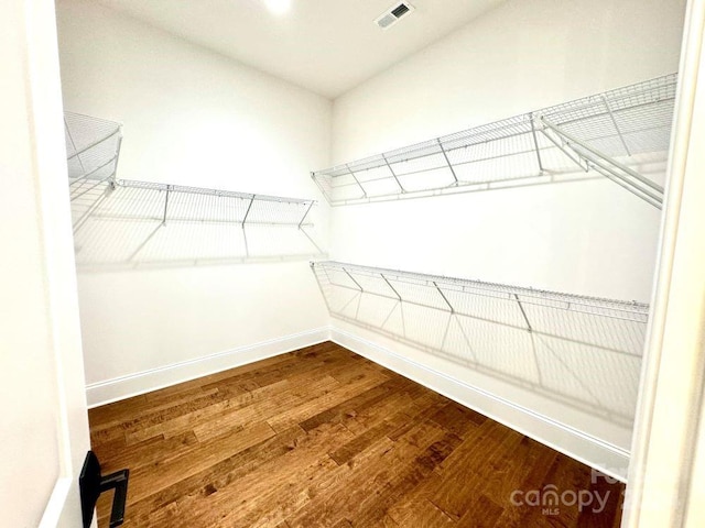 walk in closet with hardwood / wood-style floors