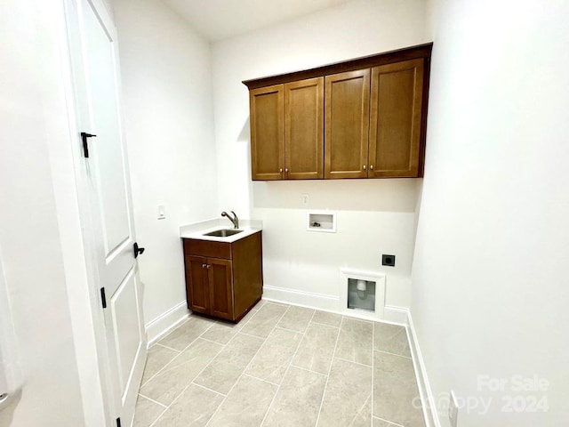 clothes washing area featuring light tile patterned flooring, sink, cabinets, hookup for a washing machine, and electric dryer hookup