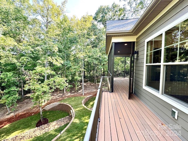 wooden terrace with a lawn