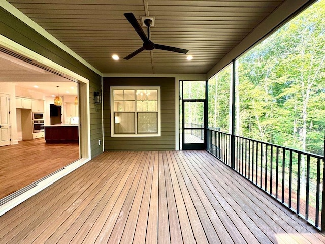 wooden terrace featuring ceiling fan