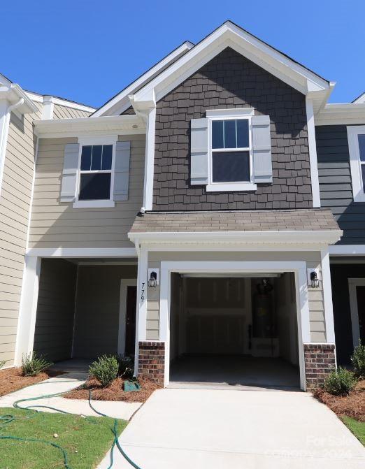 craftsman-style home with concrete driveway and an attached garage