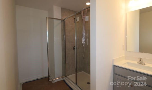 bathroom featuring vanity and an enclosed shower