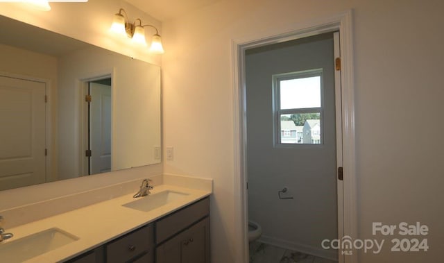 bathroom featuring vanity and toilet