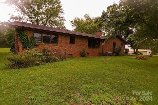 exterior space with a front lawn and cooling unit