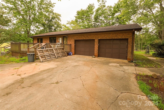 ranch-style home featuring a garage and a deck