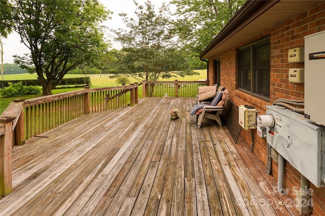 wooden deck featuring a lawn