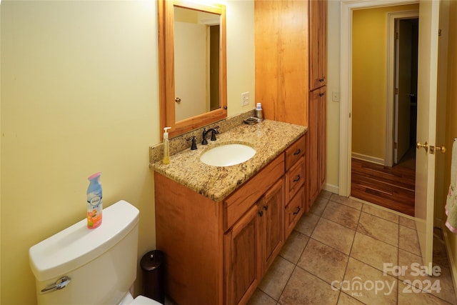 bathroom with vanity, toilet, and tile patterned flooring