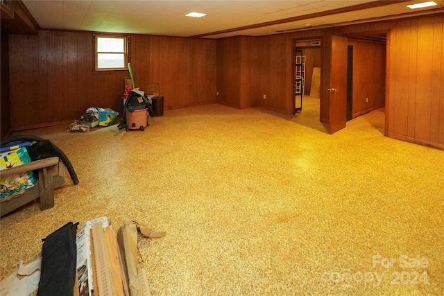 basement featuring wooden walls