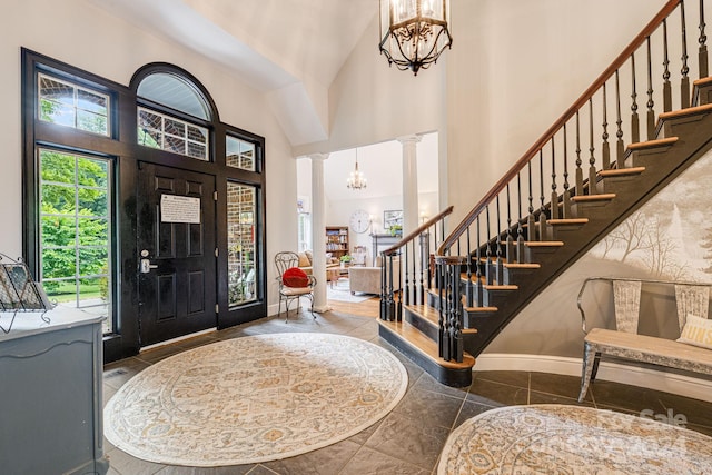 entrance foyer featuring an inviting chandelier, a high ceiling, and decorative columns