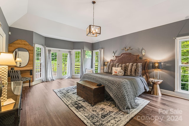 bedroom with french doors, hardwood / wood-style flooring, access to outside, and a notable chandelier