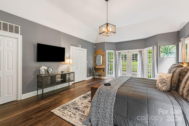 bedroom featuring french doors, dark hardwood / wood-style flooring, and a notable chandelier