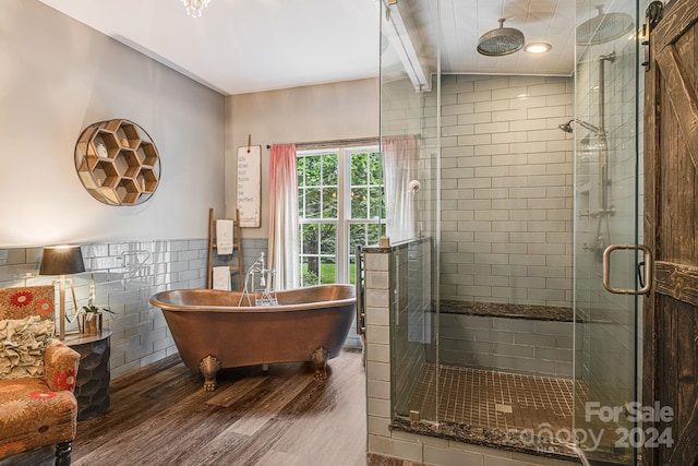 bathroom with wood-type flooring, tile walls, vaulted ceiling with beams, and plus walk in shower