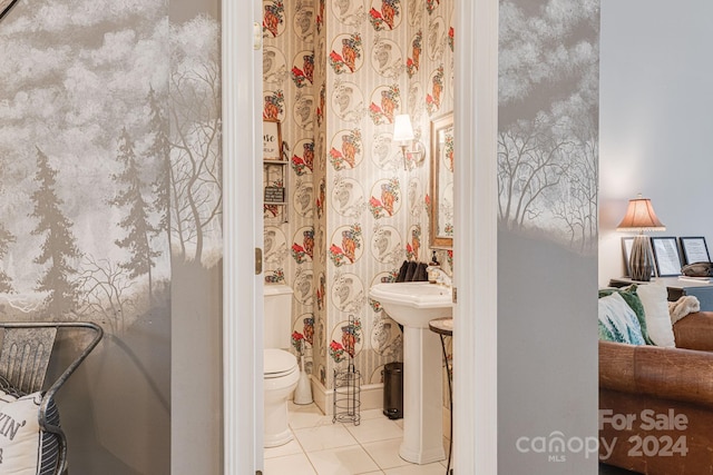 bathroom featuring toilet and tile patterned flooring