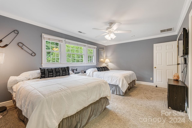 carpeted bedroom featuring ceiling fan and ornamental molding