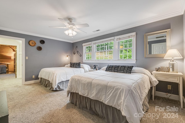 carpeted bedroom featuring ceiling fan and crown molding