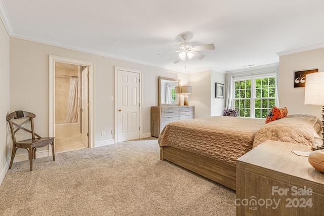 bedroom featuring ceiling fan, ornamental molding, light colored carpet, and ensuite bath