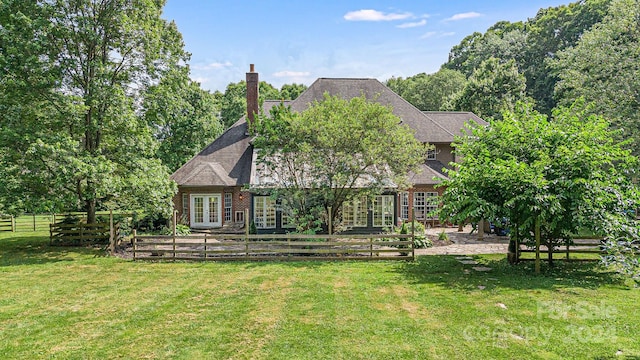 back of house featuring french doors and a yard