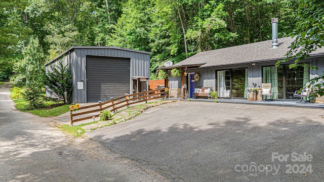 exterior space with a garage and an outdoor structure