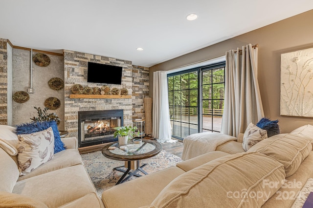 living room featuring a stone fireplace