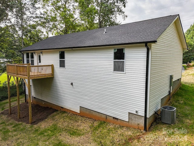 rear view of house featuring central AC, a yard, and a wooden deck