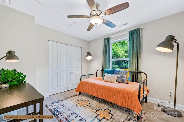 bedroom with a closet, ceiling fan, and light hardwood / wood-style floors