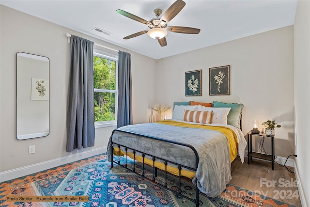 bedroom with ceiling fan and dark hardwood / wood-style floors