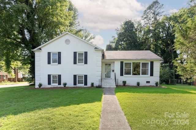 tri-level home with a front lawn