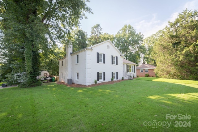 view of property exterior featuring a yard and cooling unit