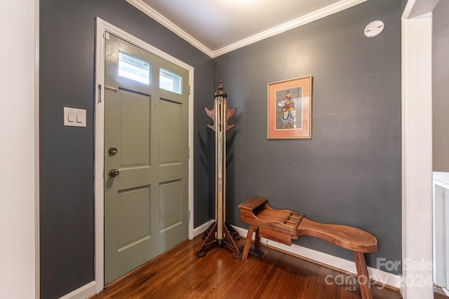 foyer with ornamental molding and dark hardwood / wood-style floors