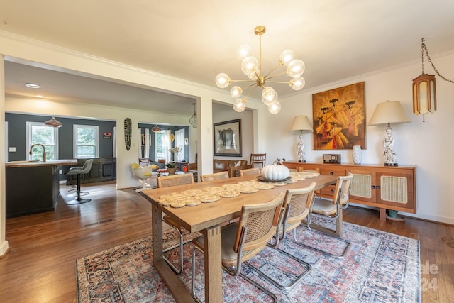 dining room featuring ornamental molding, dark wood-type flooring, and a notable chandelier