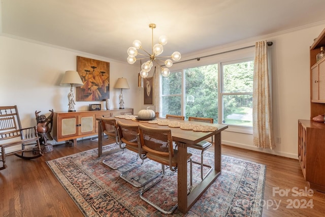 dining room with an inviting chandelier, crown molding, and dark hardwood / wood-style floors