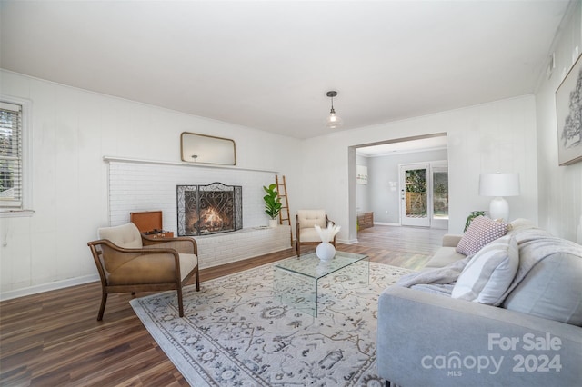 living room featuring a fireplace and dark hardwood / wood-style floors