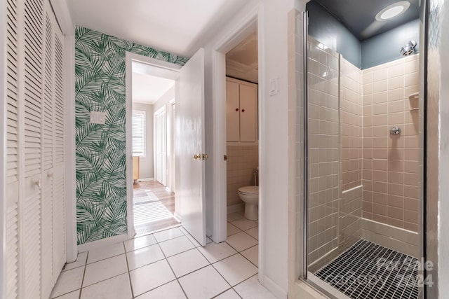 bathroom with toilet, walk in shower, and tile patterned flooring