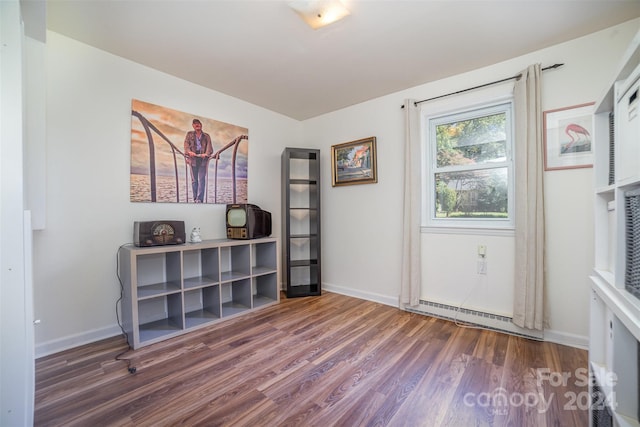 interior space with dark hardwood / wood-style floors and baseboard heating