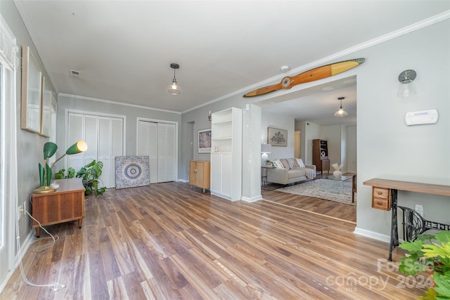 interior space featuring ornamental molding and hardwood / wood-style floors