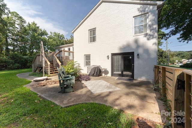 back of house featuring a patio and a lawn