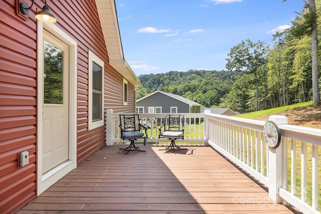 wooden deck featuring a view of trees