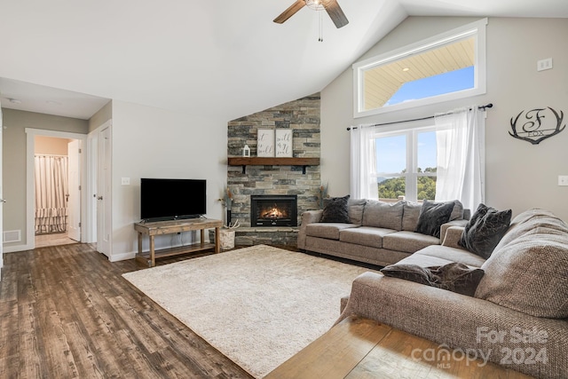 living area with ceiling fan, high vaulted ceiling, dark wood-type flooring, a fireplace, and baseboards