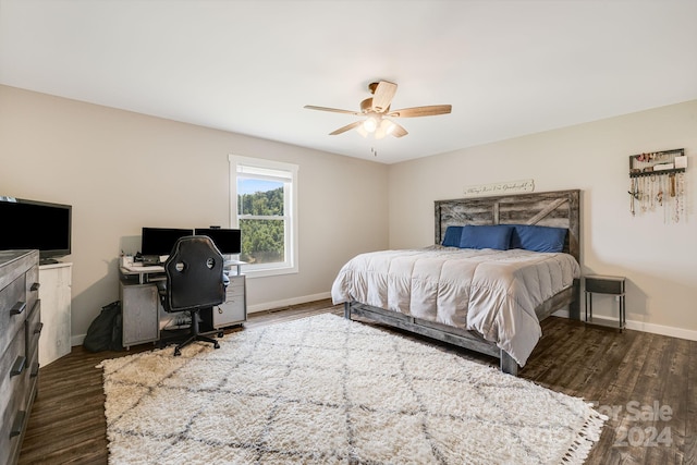 bedroom featuring ceiling fan, baseboards, and wood finished floors