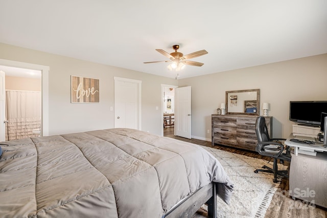 bedroom featuring ceiling fan, wood finished floors, and baseboards