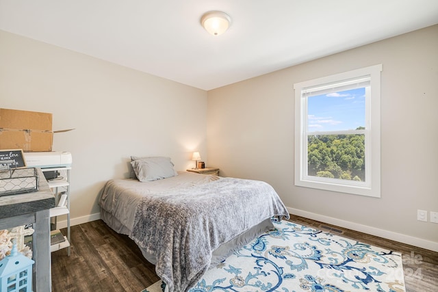 bedroom featuring dark wood-style flooring and baseboards